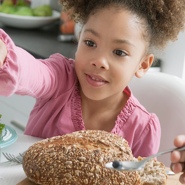 Photo of girl with whole wheat bread.
