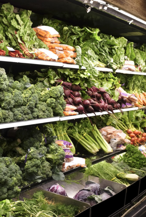 A colorful assortment of fresh fruits and vegetables on display in a grocery store.