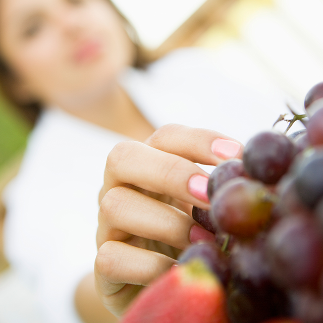 Mujer escogiendo uvas